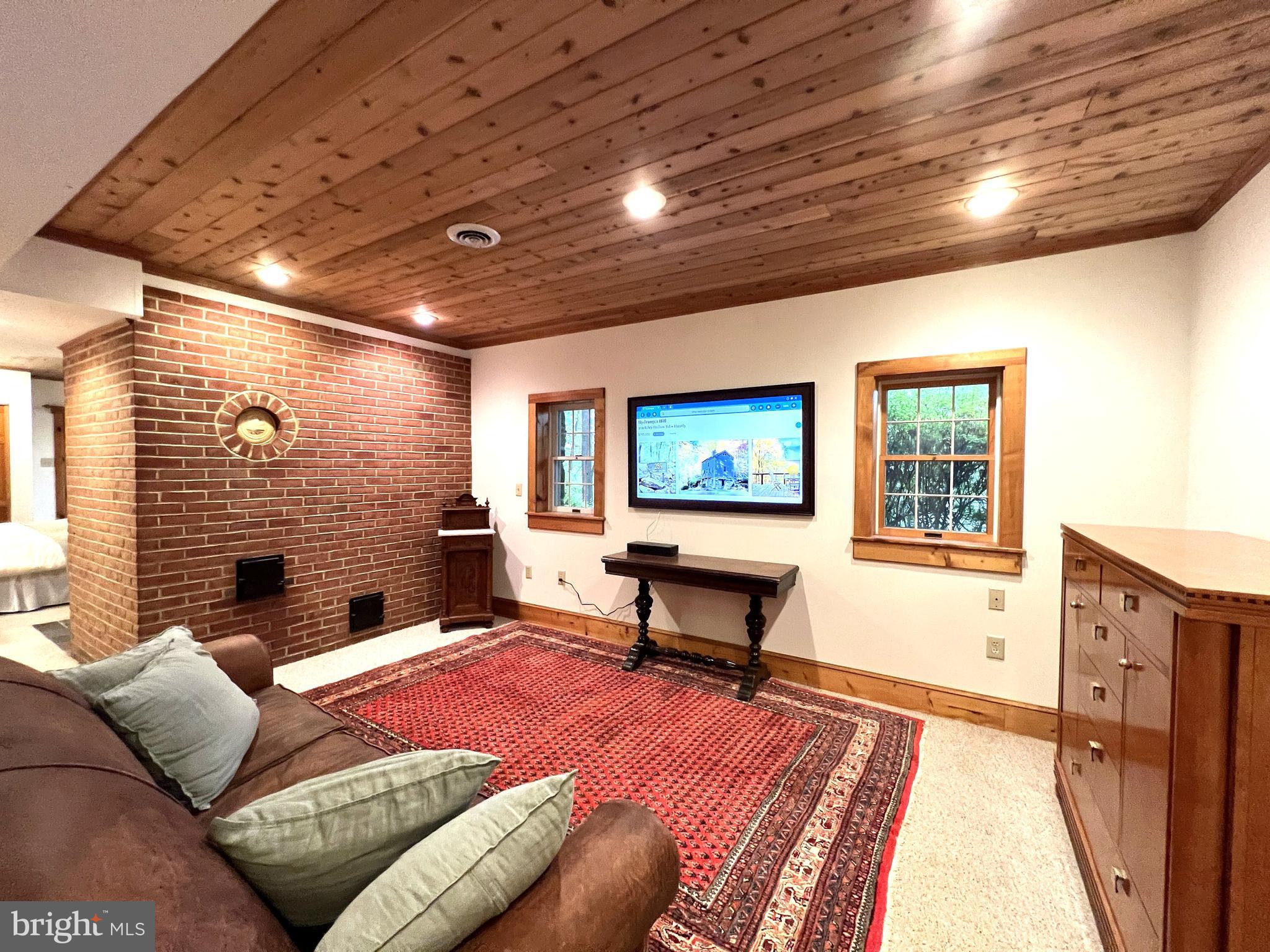 259 Riley Hollow Road Huntly, VA 22640 - Photo 19 of 33 a living room with furniture a flat screen tv and a fireplace