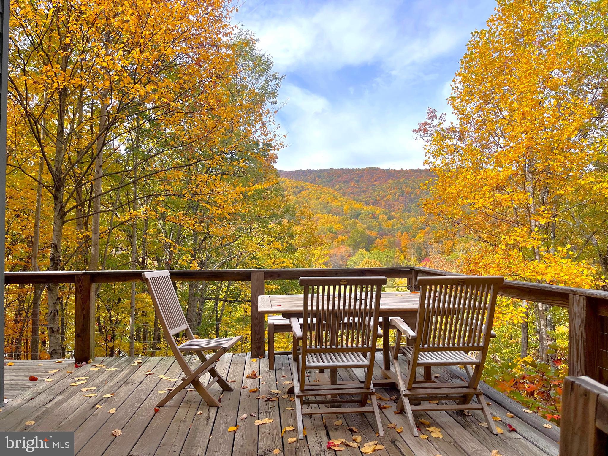 259 Riley Hollow Road Huntly, VA 22640 - Photo 5 of 33 a view of a balcony with chairs and wooden fence