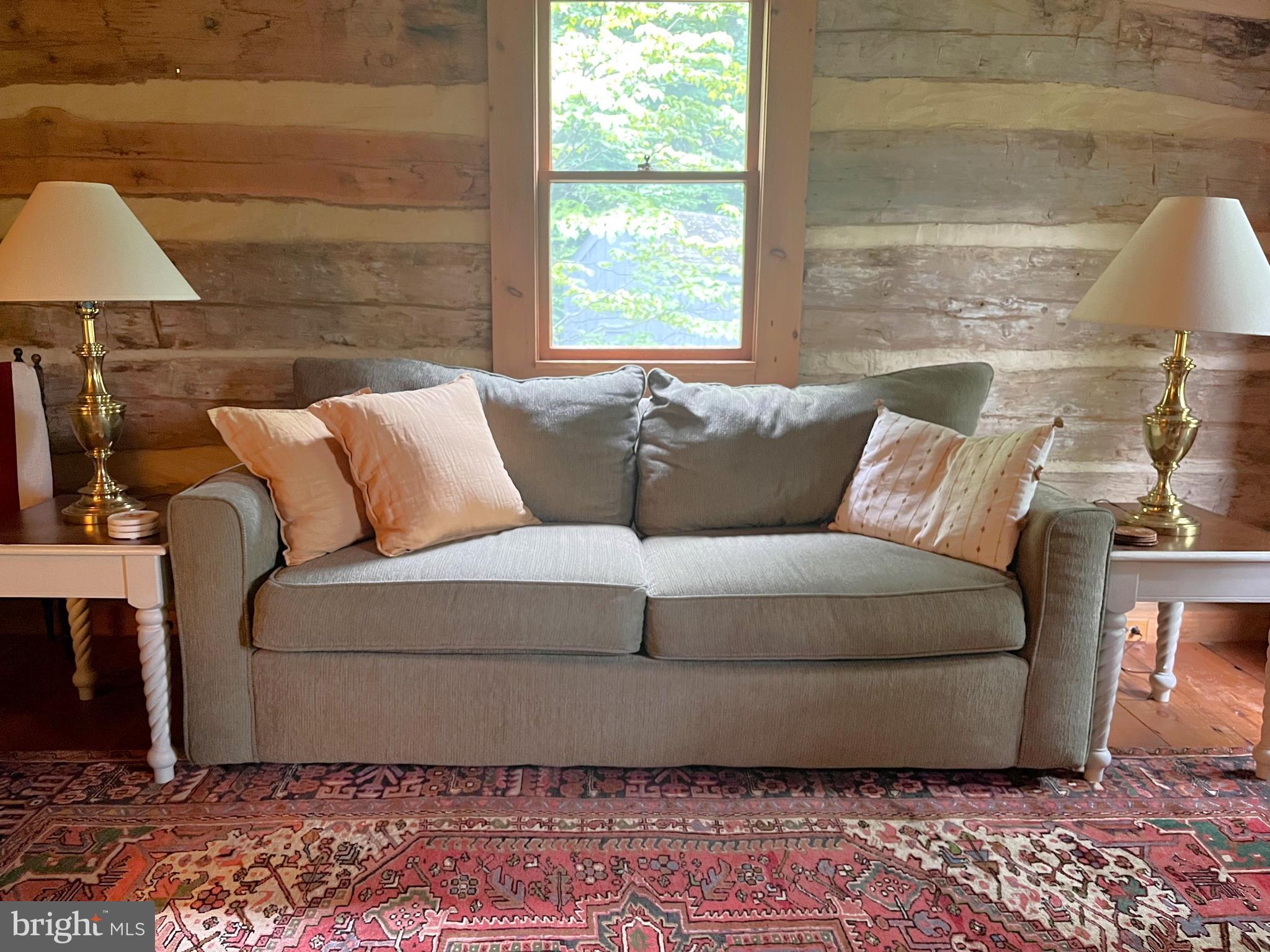 259 Riley Hollow Road Huntly, VA 22640 - Photo 8 of 33 a living room with a couch and a lamp next to a window