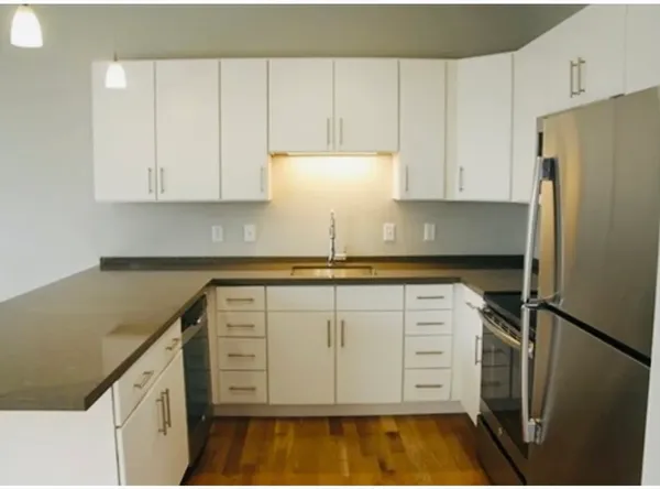 a kitchen with appliances cabinets and a counter top space