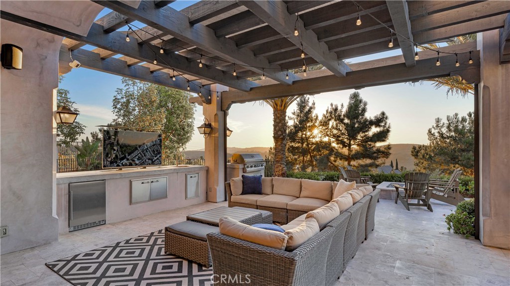2 Thomas Road Ladera Ranch, CA 92694 - Photo 30 of 69 Host unforgettable gatherings with the outdoor kitchen, firepit and bluestone travertine decking. From your comfortable living area, watch favorite shows from a hidden automated TV station.