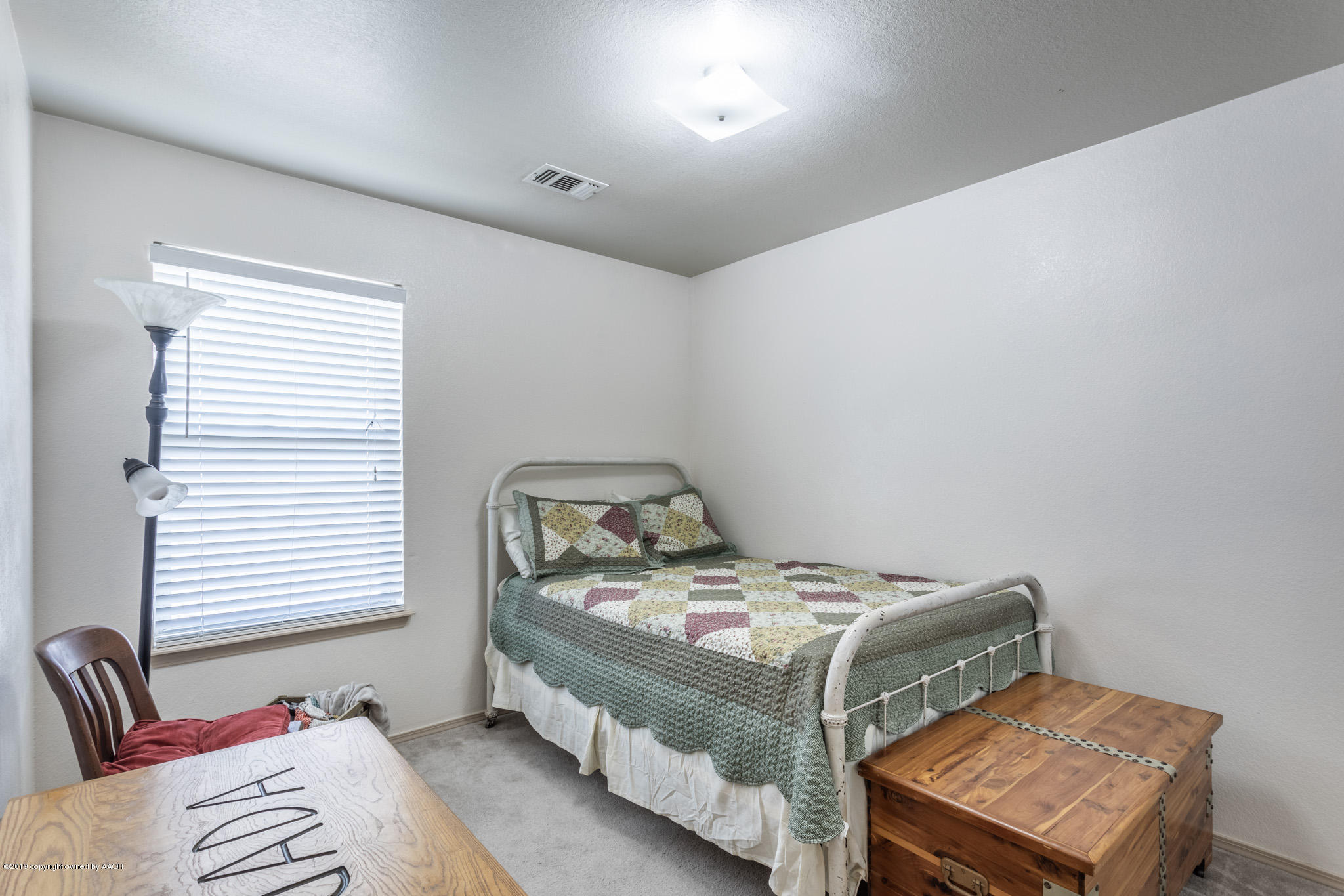 1111 Pikes Peak Drive Amarillo, TX 79110 - Photo 11 of 15 a bed sitting in a bedroom next to a window
