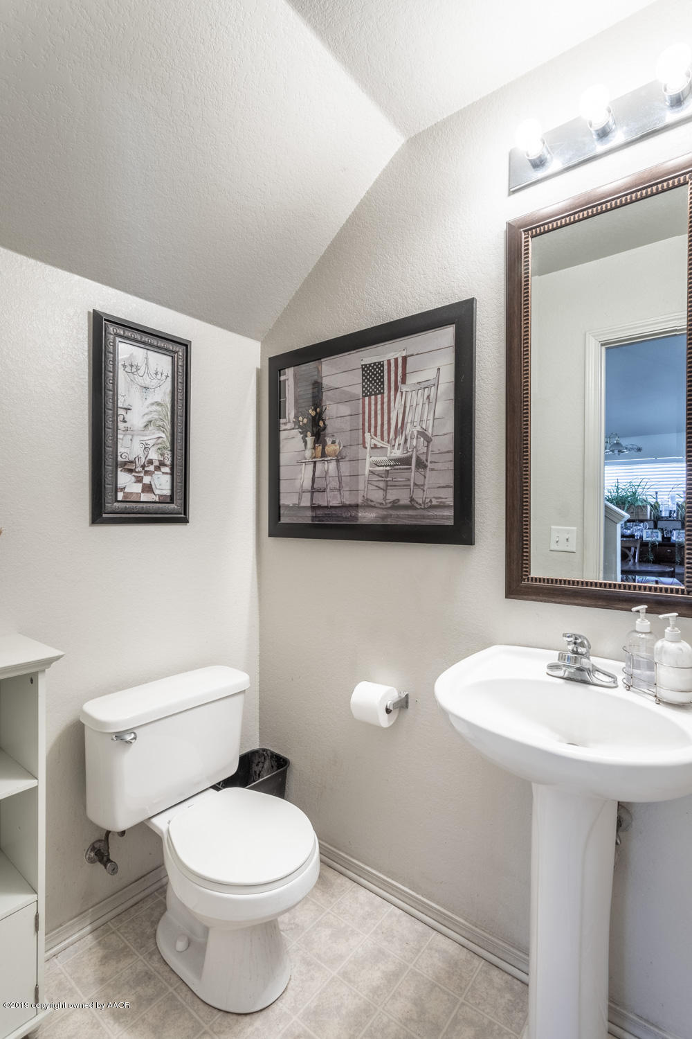 1111 Pikes Peak Drive Amarillo, TX 79110 - Photo 13 of 15 a bathroom with a toilet sink and mirror