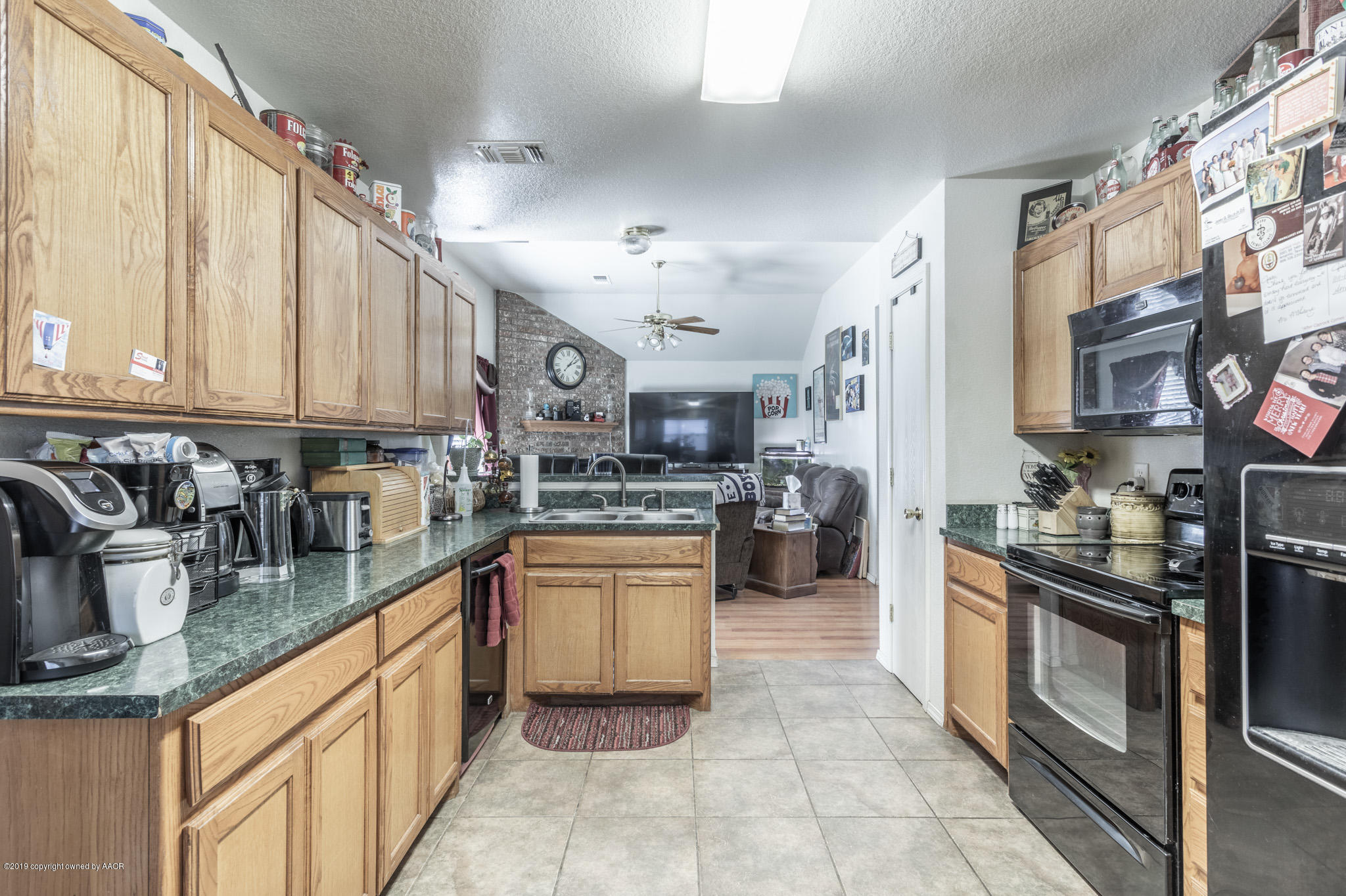 1111 Pikes Peak Drive Amarillo, TX 79110 - Photo 3 of 15 a kitchen with stainless steel appliances granite countertop a sink and cabinets