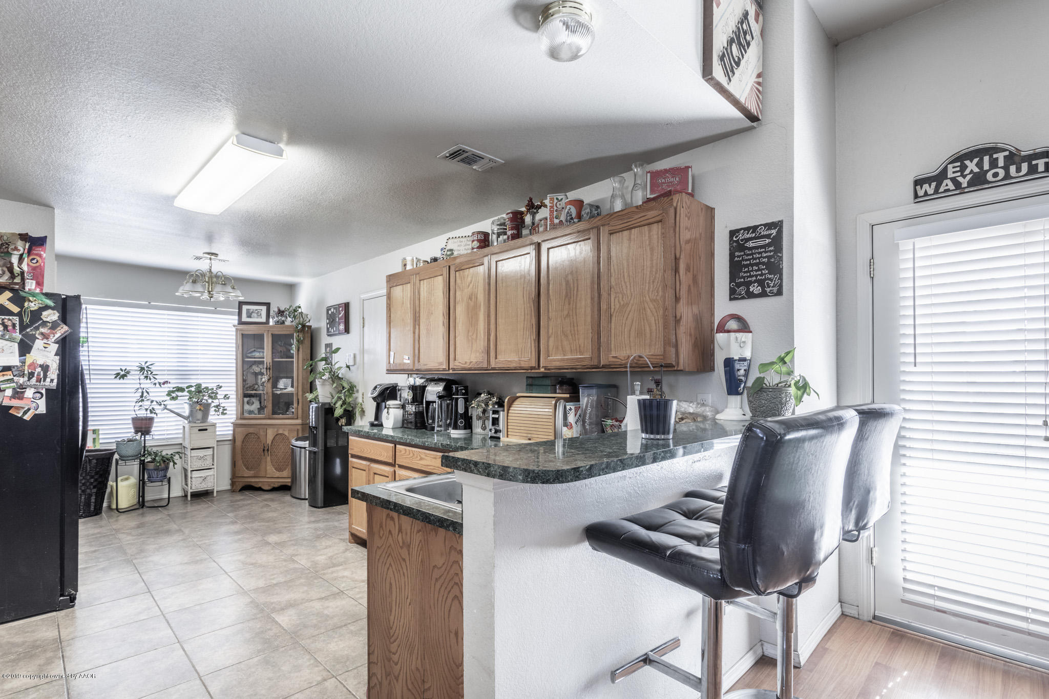 1111 Pikes Peak Drive Amarillo, TX 79110 - Photo 4 of 15 a kitchen with a refrigerator and a stove