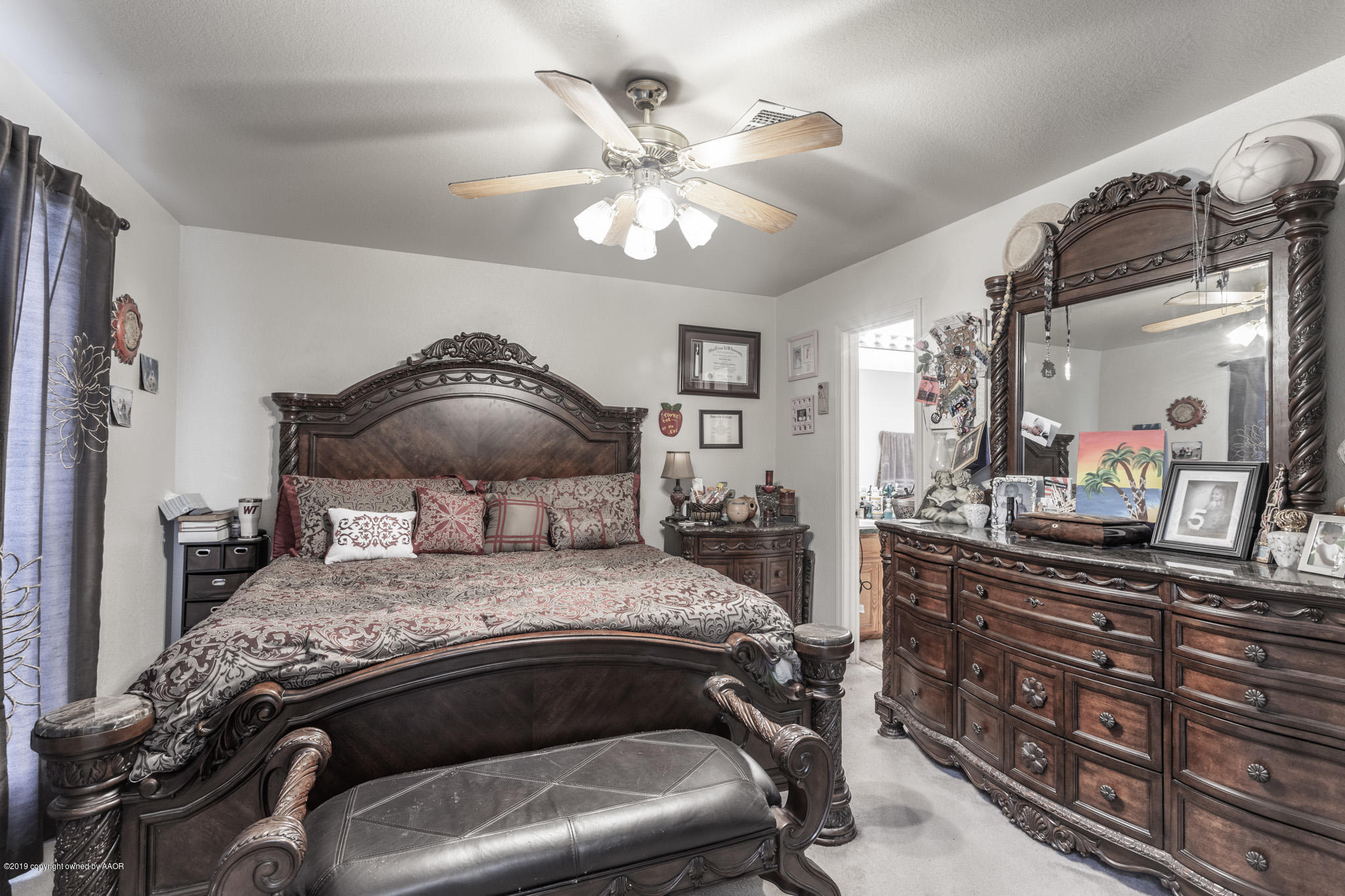 1111 Pikes Peak Drive Amarillo, TX 79110 - Photo 8 of 15 a bedroom with a bed and a chandelier