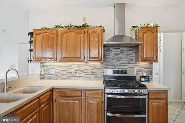a kitchen with a stove a sink and a refrigerator