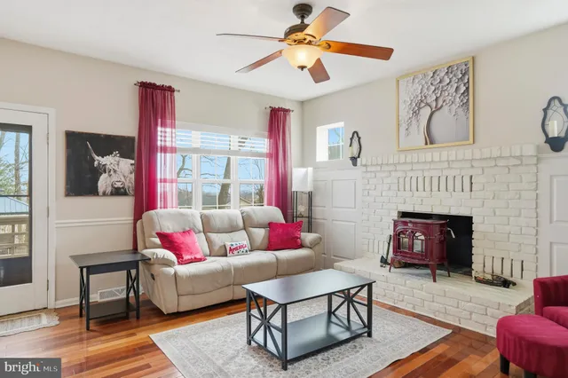 a living room with furniture fireplace and flat screen tv
