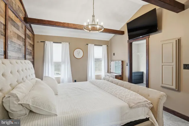 a bedroom with a bed and a chandelier