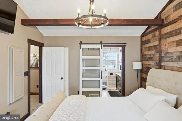 a bedroom with a bed and a chandelier