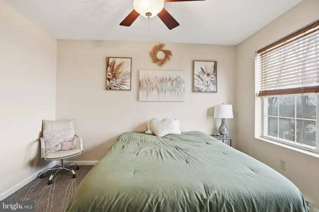 a bedroom with a large bed and a window