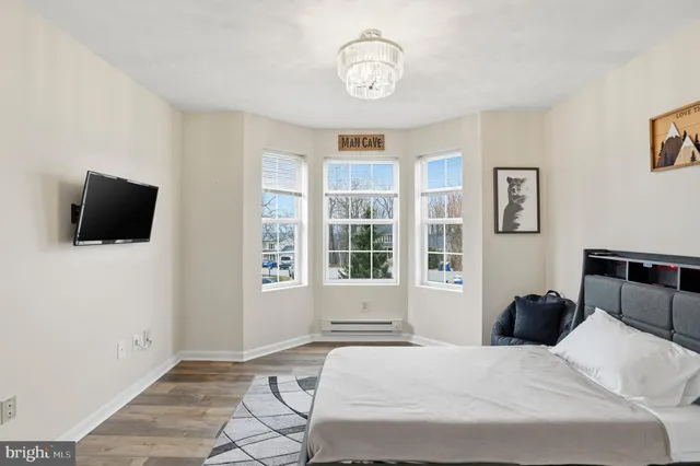 a view of a workspace with furniture and wooden floor