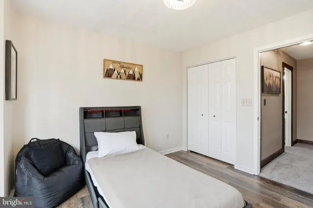 a bedroom with a bed tv and window