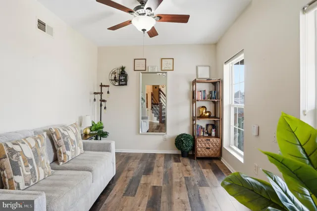 a living room with furniture and wooden floor