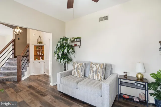 a living room with furniture and a potted plant