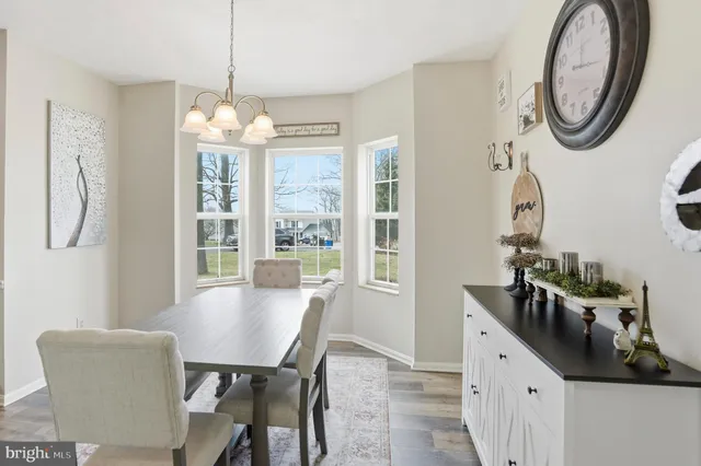 a dining room with furniture a chandelier and a rug