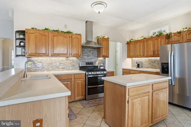 a kitchen with a stove cabinets and refrigerator