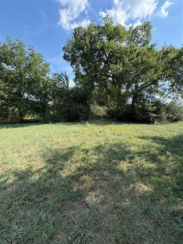 a view of a green yard with a house