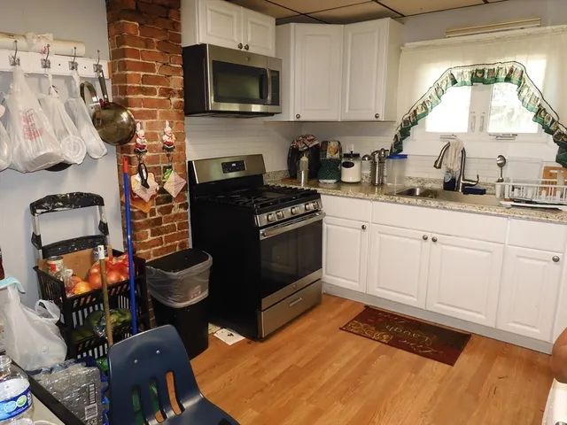 a view of a room with furniture and wooden floor