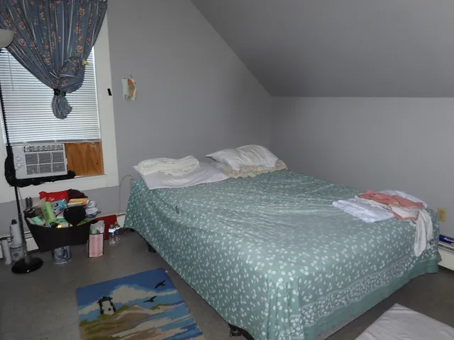 a bedroom with bed and a dresser