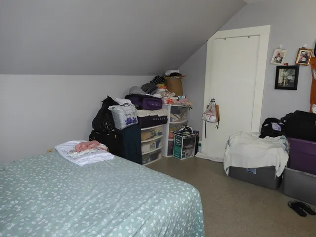 a bedroom with a bed and a table