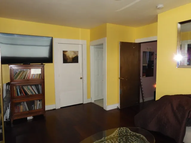 a living room with furniture and a book shelf