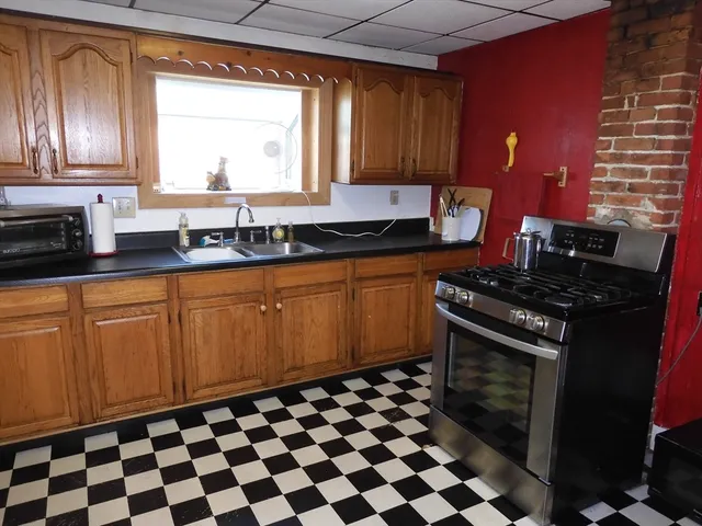 a kitchen with black stainless steel appliances a stove a sink and a microwave