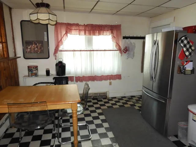 a bathroom with a black white checkered floor and a large window
