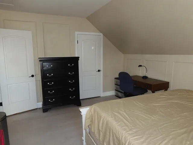 a bedroom with a bed and a closet