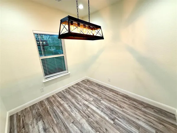 a view of wooden floor and a chandelier in a room