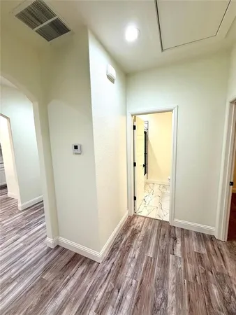 a view of hallway with wooden floor