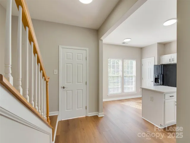 a view of a kitchen with wooden floor and entryway