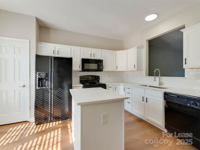 a kitchen with a sink a stove and refrigerator