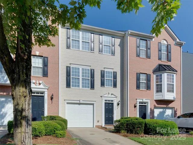 a front view of a building with a garden