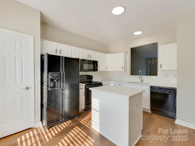 a kitchen that has a sink and a stove in it