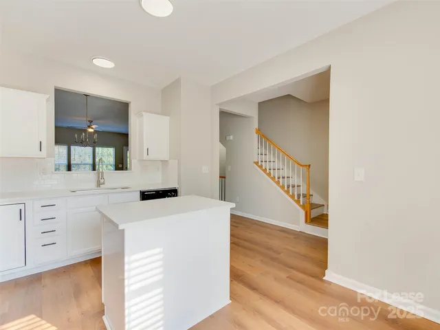 a kitchen with stainless steel appliances a stove a sink and a microwave