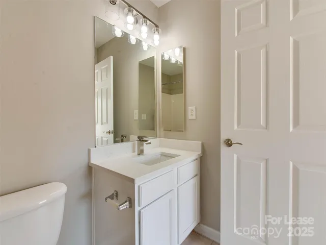 a bathroom with a sink toilet a mirror and shower