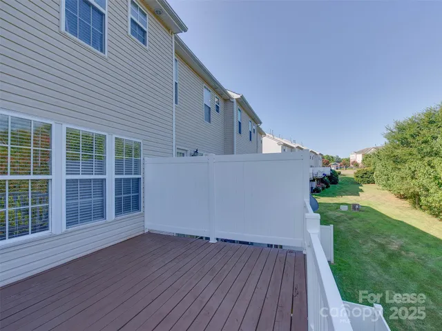 a view of a deck with wooden floor and fence