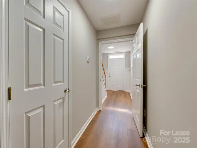 a view of a hallway with wooden floor