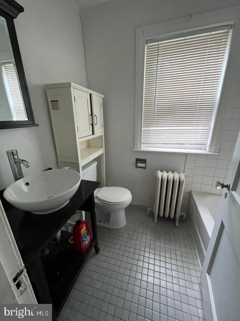 5010 Copley Road Philadelphia, PA 19144 - Photo 4 of 6 a bathroom with a sink toilet and mirror