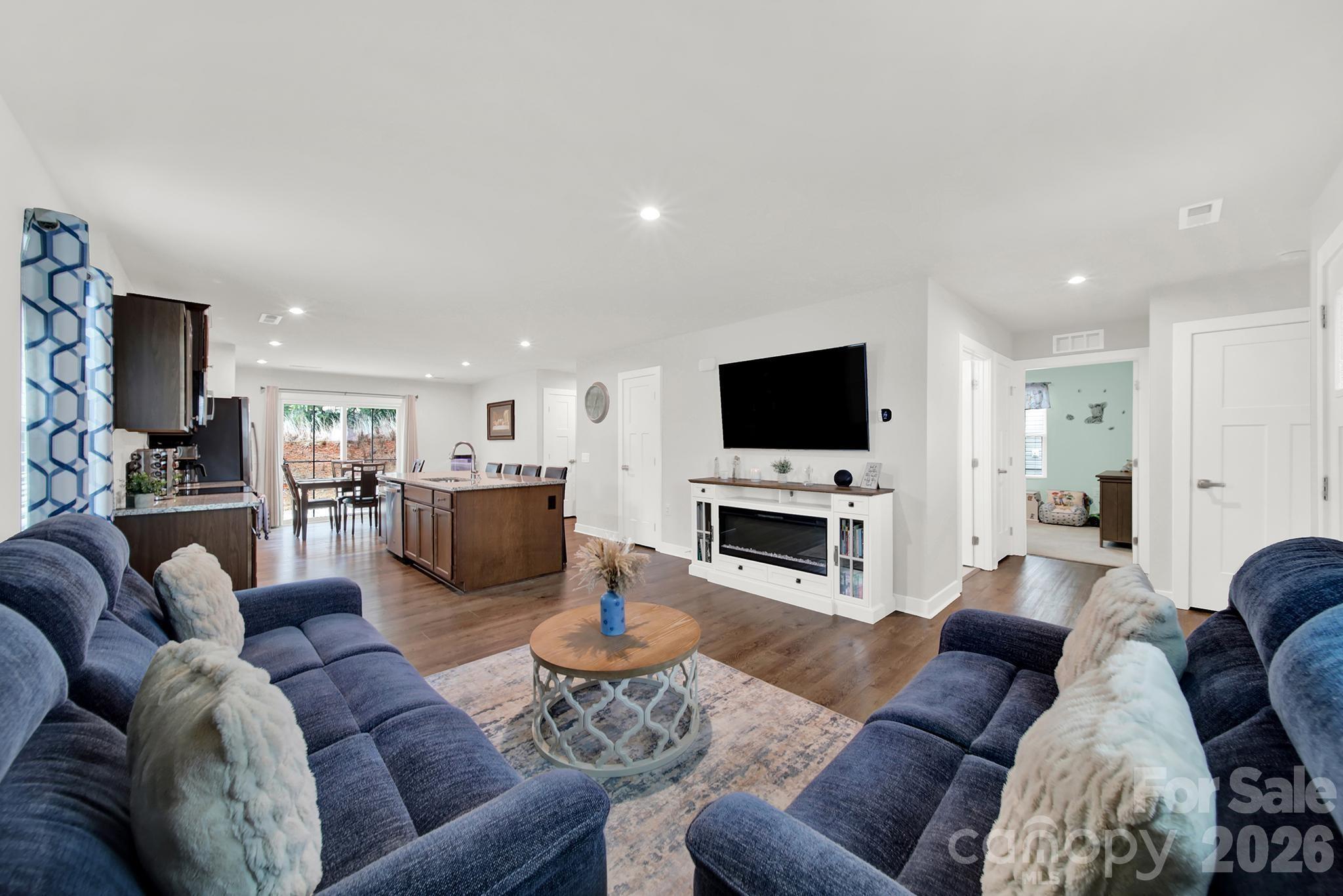 a living room with furniture flat screen tv and fireplace