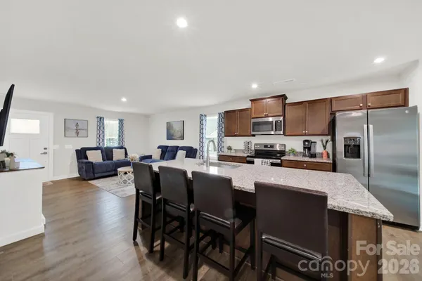 a large kitchen with a table and chairs