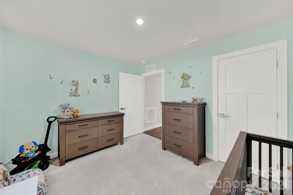 a bed room with a bed and a dresser