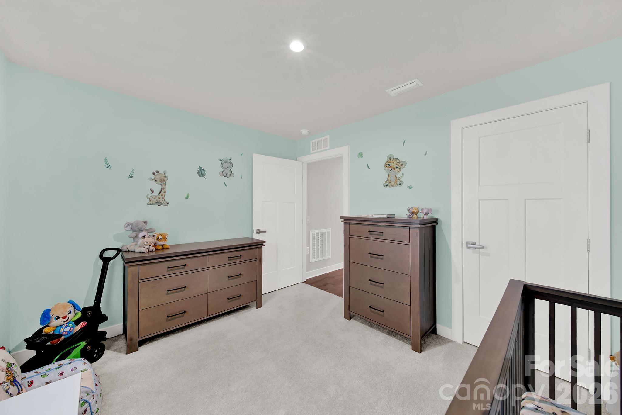 515 Grandiflora Avenue Lancaster, SC 29720 - Photo 16 of 29 a bed room with a bed and a dresser