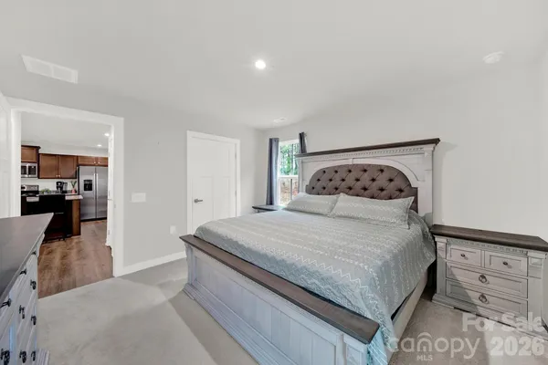 a bedroom with a bed and cabinet