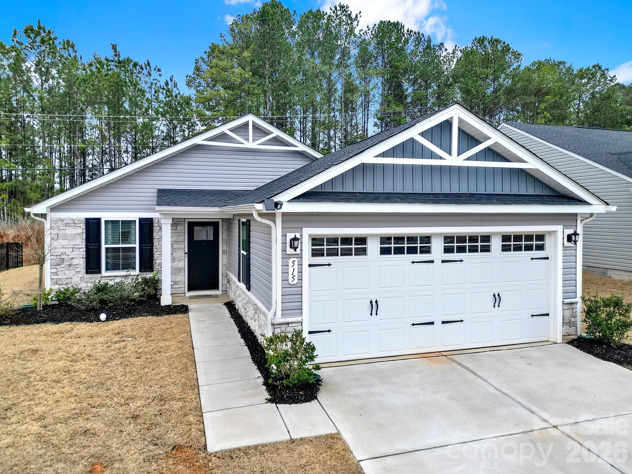 515 Grandiflora Avenue Lancaster, SC 29720 - Photo 2 of 29 a front view of house with yard and trees in the background