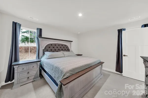 a bedroom with a bed and window