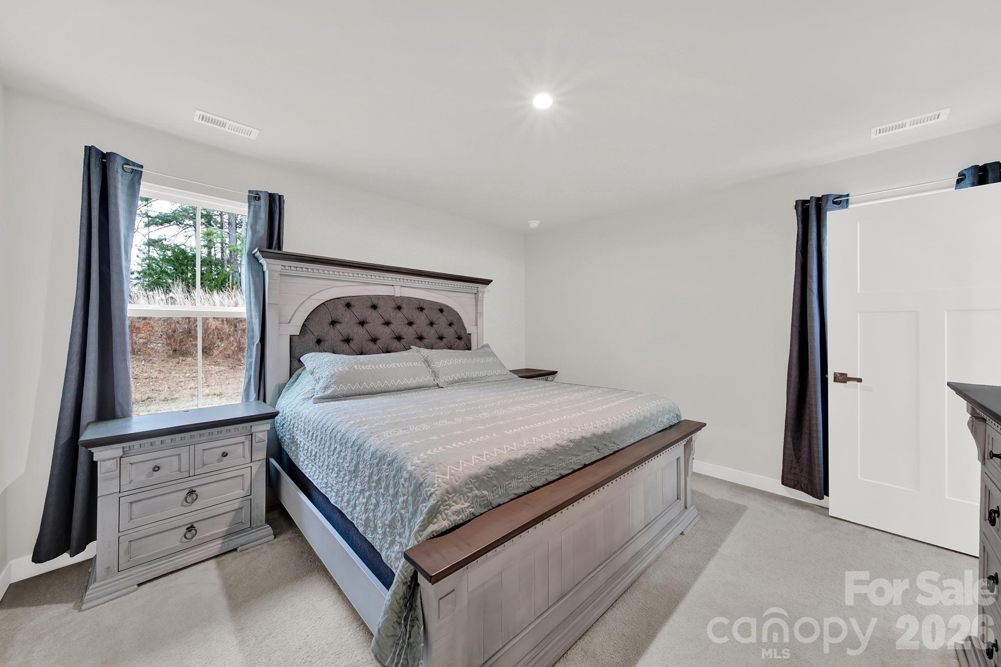 515 Grandiflora Avenue Lancaster, SC 29720 - Photo 21 of 29 a bedroom with a bed and window