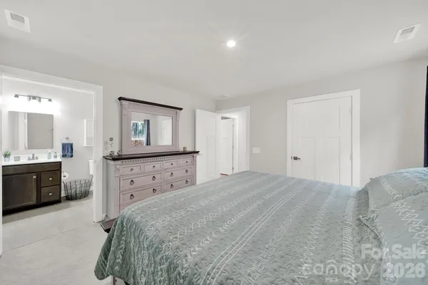 a bedroom with a bed and a dresser