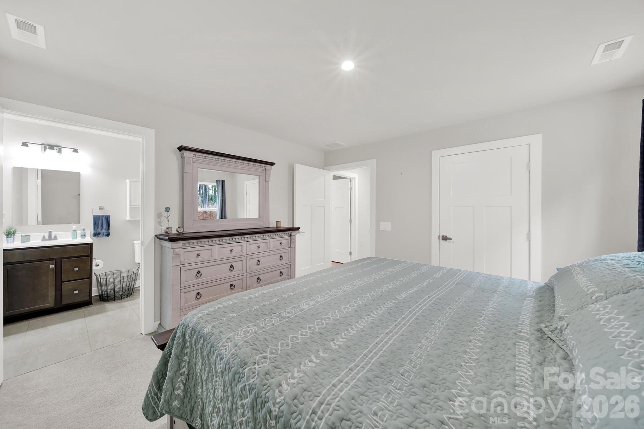 515 Grandiflora Avenue Lancaster, SC 29720 - Photo 22 of 29 a bedroom with a bed and a dresser